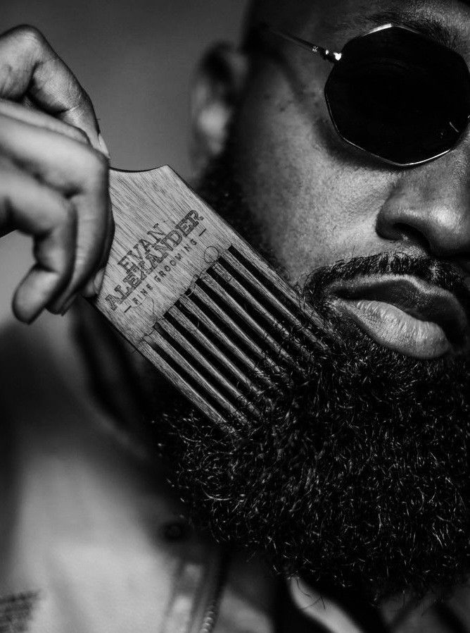 Close-up of a wooden comb through a beard