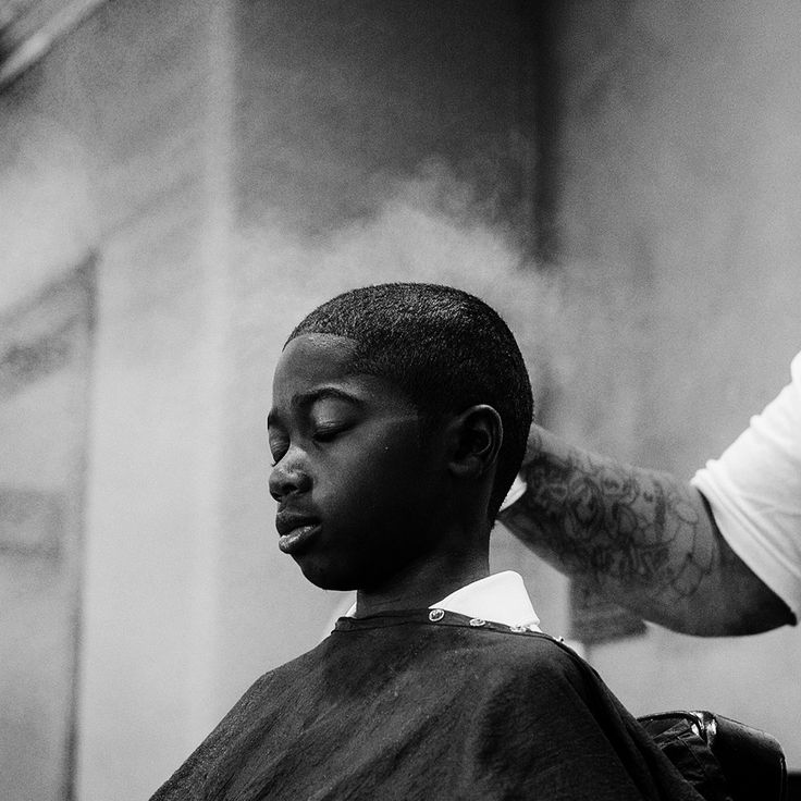 Young client mid-haircut, eyes closed